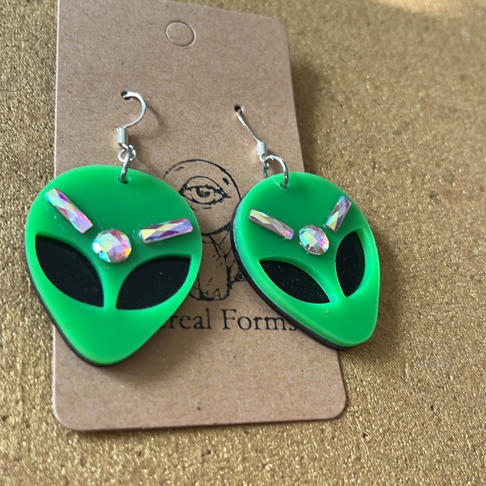 Green alien dangle earrings with pink holographic rhinestones